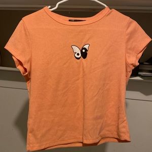Hello! This is a peach Yin-Yang butterfly shirt by Faded Rose.